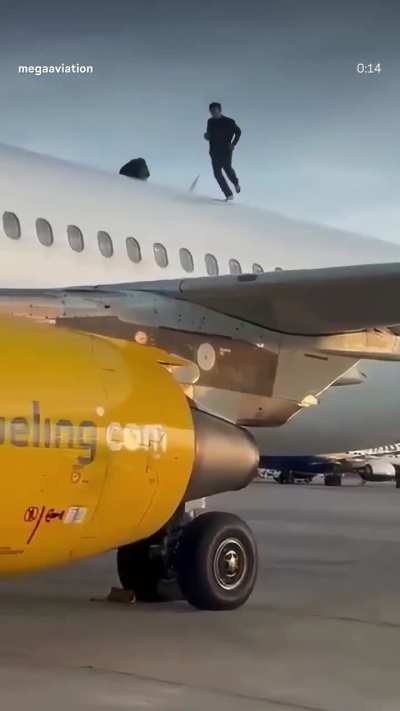 Moroccan dude climbs plane in Spain