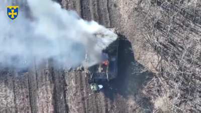 Ukrainian drone pilot drops a US M67 grenade into the open hatch of a damaged Russian BMP-3 IFV.