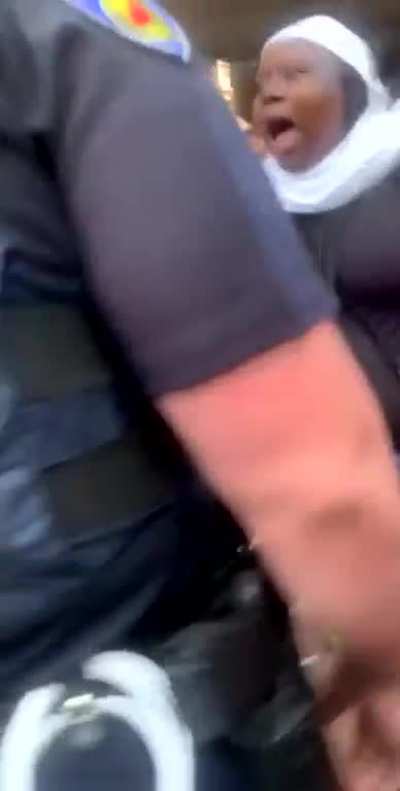 Officer gets confronted by another officer for pushing a girl who was on her knees with her hands up.