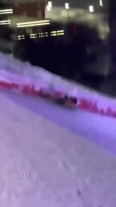 Sliding down snow covered stairs on a floater.