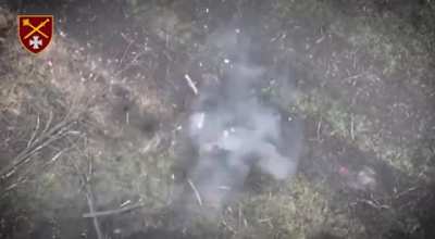 Russian soldier pulls pin on a grenade after being wounded 