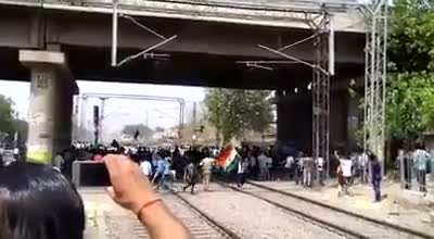 Stand on tracks in an attempt to stop a high speed train