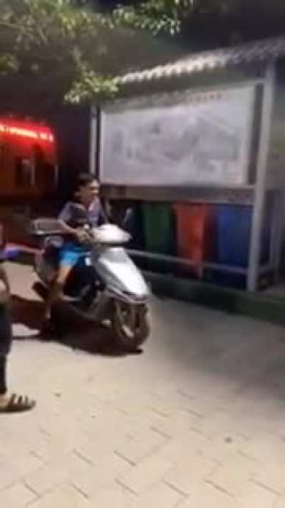 Trying to park a scooter. No planning and no helmet.