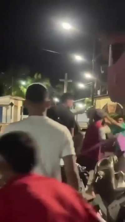 A group of people jump a man wielding a machete that was chasing a young lady around