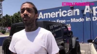Paparazzi shove a camera in Nipsey Hussle's face and get reminded he's a legit gang member