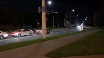 Man escapes riot police by getting into a taxi, which drives away instantly