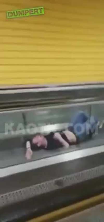 Man recieves heimlich maneuver from escalator