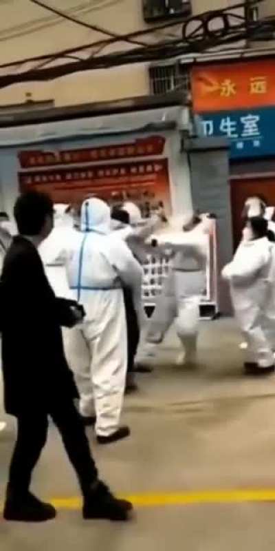 10 Chinese health officials drag citizen out of complex and kick and beat them on the ground before taking them away in locked down Xi'an city due to Hemorrhagic Fever concerns