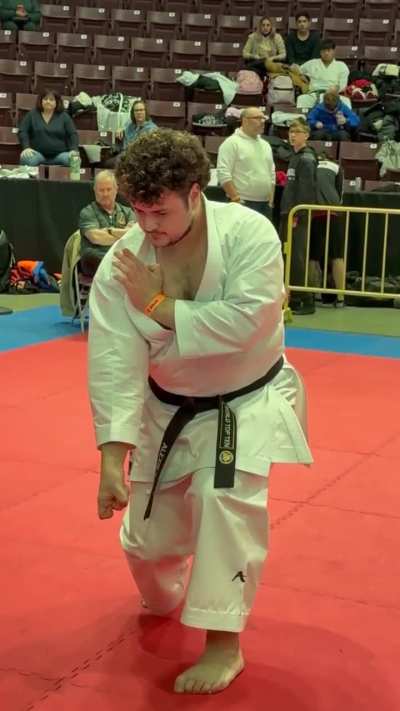 A dude performing at a traditional karate competition