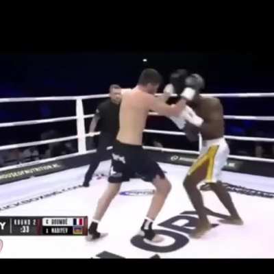 C&eacute;dric Doumb&eacute; counters the knee to the body.