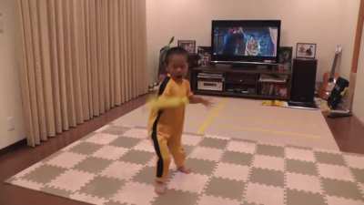 5 year old kid enacting Bruce Lee's epic nunchaku scene in Game of Death