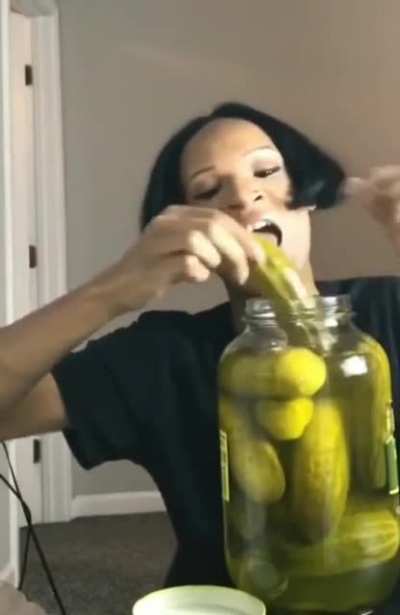 Unidentified gender person eating pickles