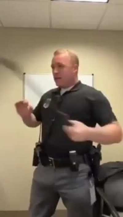Police officer demonstrating his baton techniques.