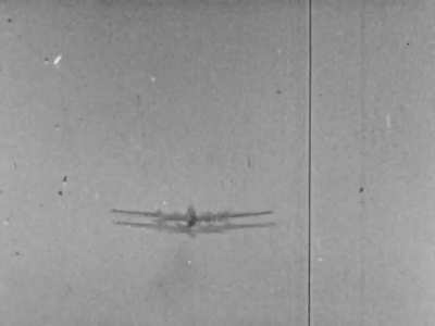 Parts fly off a Boeing B-17 Flying Fortress singled out by a Luftwaffe fighter in early 1944