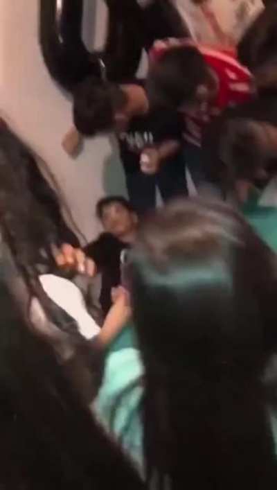 Kid plays a prank to his mom and friends during a birthday cake.