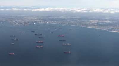 Someone took video of ships waiting for berths at Long Beach/Los Angeles while they flew into OC airport 30 miles down the coast