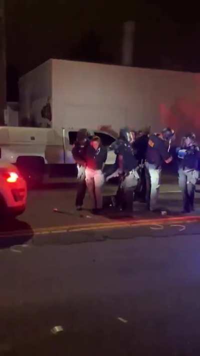 Portland police removing journalist's press badge and stealing her cash from her pockets as she vomits from tear gas exposure. Portland police arrested her for walking across the street.