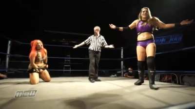Rhea fires a powerful kick between the legs of Kellyanne