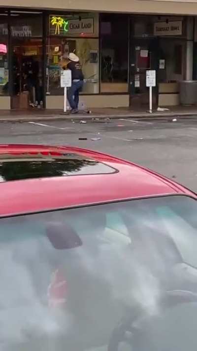 Store owners convince a pack of looters to leave their shop