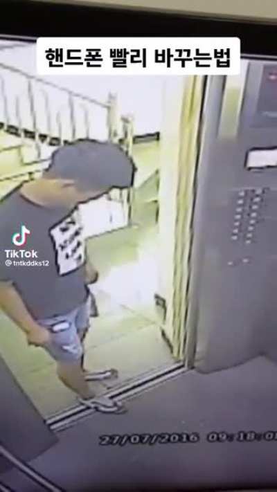 Man stands in disbelief after he drops his phone onto the elevator shaft.