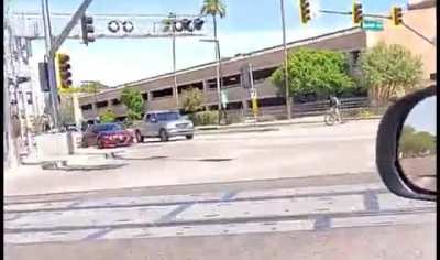 Man yells at a kid riding a bike while wearing a mask.