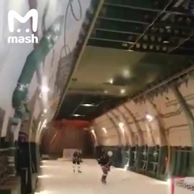 Где-то в России. Военный самолёт "AN-124" на борту которого они играют хоккей.