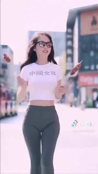 Jiggling Chinese with two spiraled hotdogs on sticks