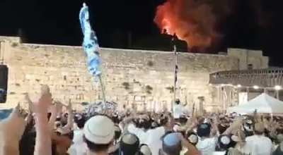 Extremist settlers having a party watching al-aqsa mosque burn during clashes between the police and worshippers