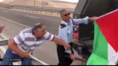 Man holding flag has it broken and torn away from him