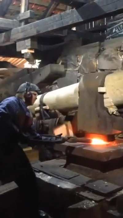 Old school mechanics for this forging hammer. Looks like it is actually powered by a water wheel.