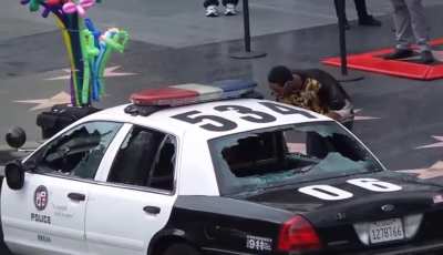 Man smashes LAPD car windows on Hollywood Boulevard and steals a laptop