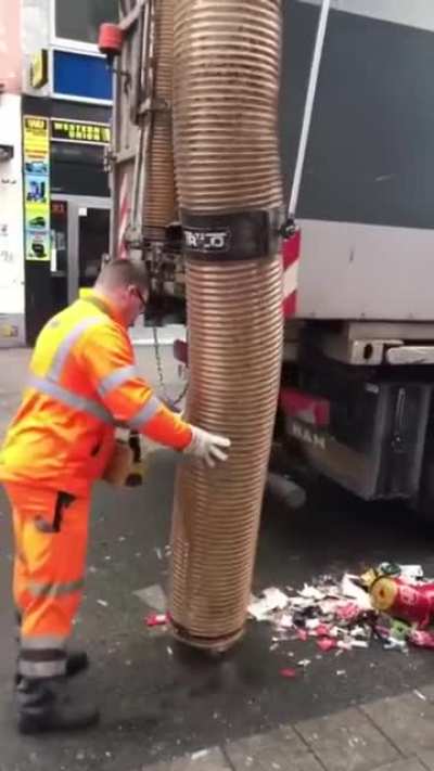 Huge street cleaning vacuum in action