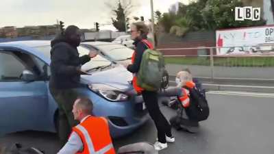 Enraged drivers drags "Insulate Britain" eco-mob activists off the road because "they have to go to work"