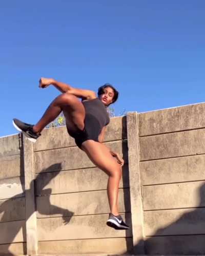 Kickboxing practitioner Alex Jay trying out a new kick. She knows that her form isn't there yet