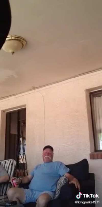 Guy sending a message to his wife in-front of his family