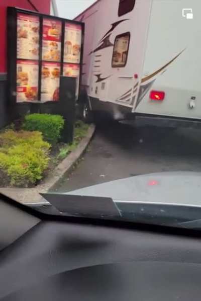 A trailer too big goes through a KFC drive-thru too small (Found on FB)