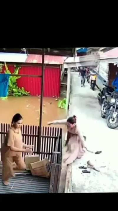 Mother dips baby's feet in dirty water