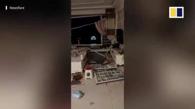 Strong winds batter China , ripping up roof