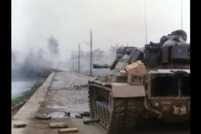 The loader in a USMC M48A3 does a bit of housekeeping as the coaxial machinegun engages PAVN/VC positions in Hue in February 1968