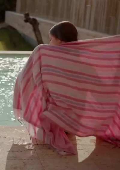 Stripping off her shirt and getting wet