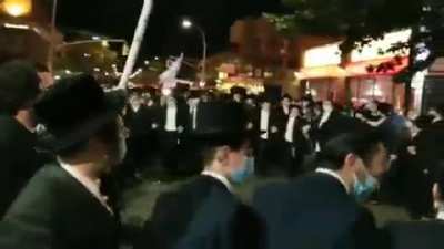 Orthodox Jews can't observe in the synagogues in New York so they've taken to the streets, and they've got Trump flags!