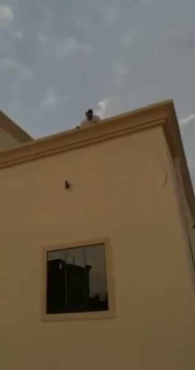 Some Arab blokes messing around with their friend