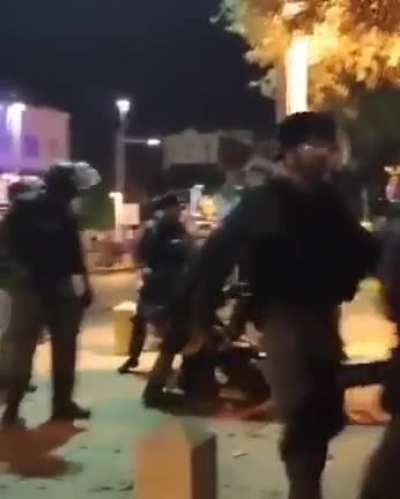 Israeli forces assaulting Palestinians, including girls.