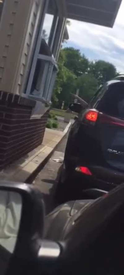 Woman mad at a Dunkin' Donuts Gets a Face Full of lced Coffee and Banshee Screams.