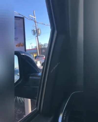 Two Older Men Handle Business In The Drive-Thru