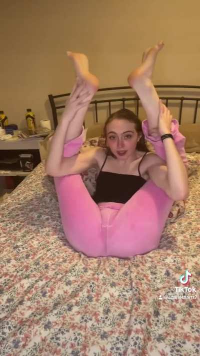 College babe sucking on her toes while her other foot is behind her head in pretzel yoga pose