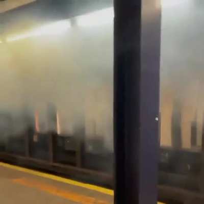 Train runs over a bycle that was thrown on the tracks , hitting the 3rd rail causing electrical fire.