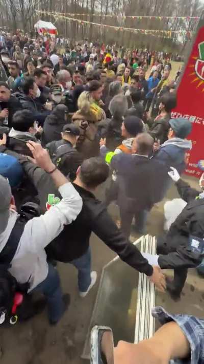 Japanese anti immigration politician Kawai Yusuke protected by police and hit in the face by a protester. Then flops wildly