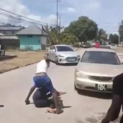 Two men fighting on the road