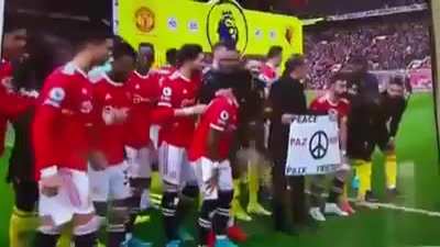 Manchester United players hold up a 
